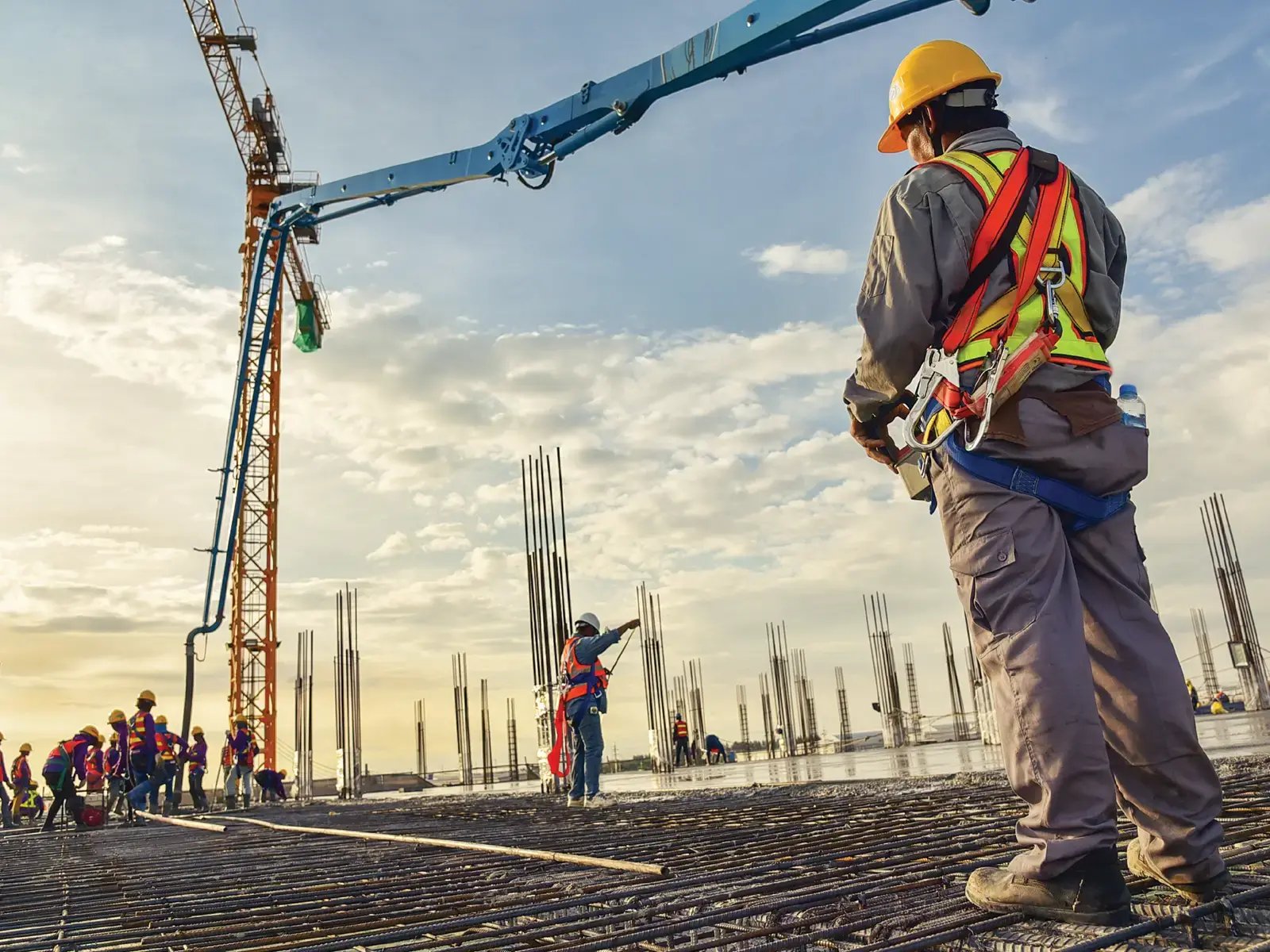 Workers overseeing concrete production