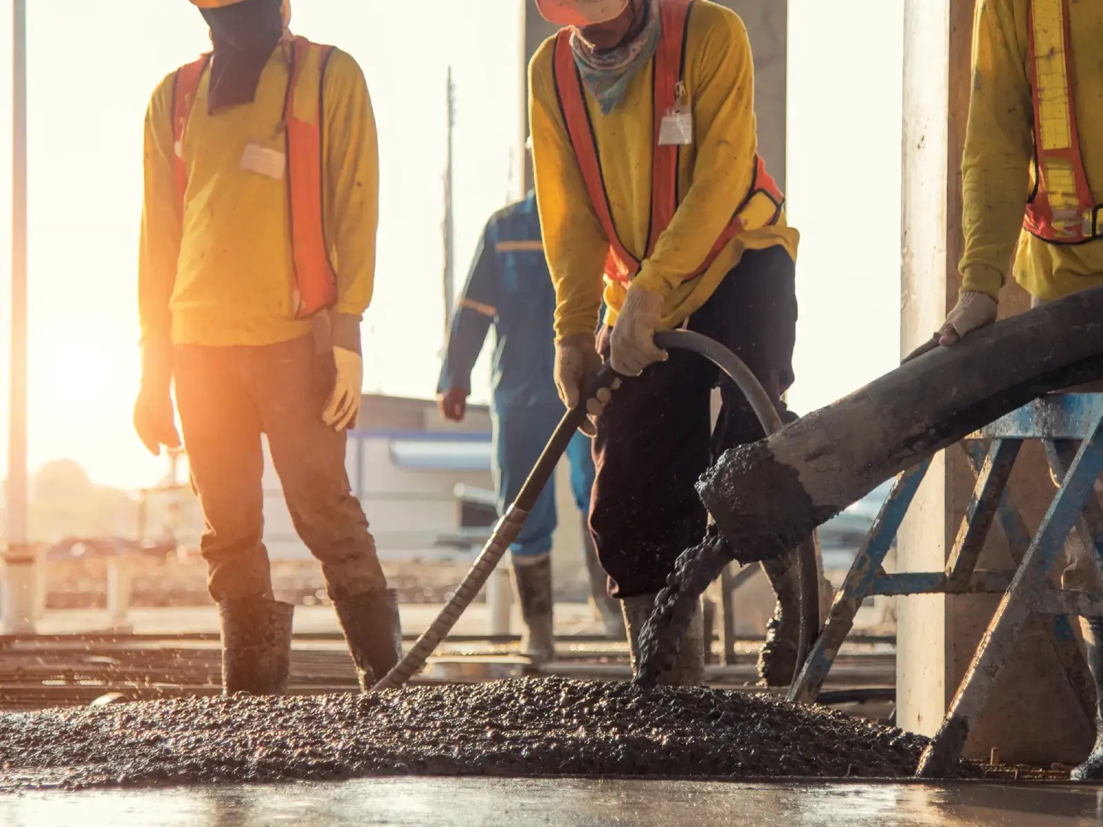 Workers pouring concrete